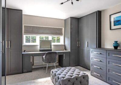 Image of bedroom with fitted wardrobes, dressing table and drawers