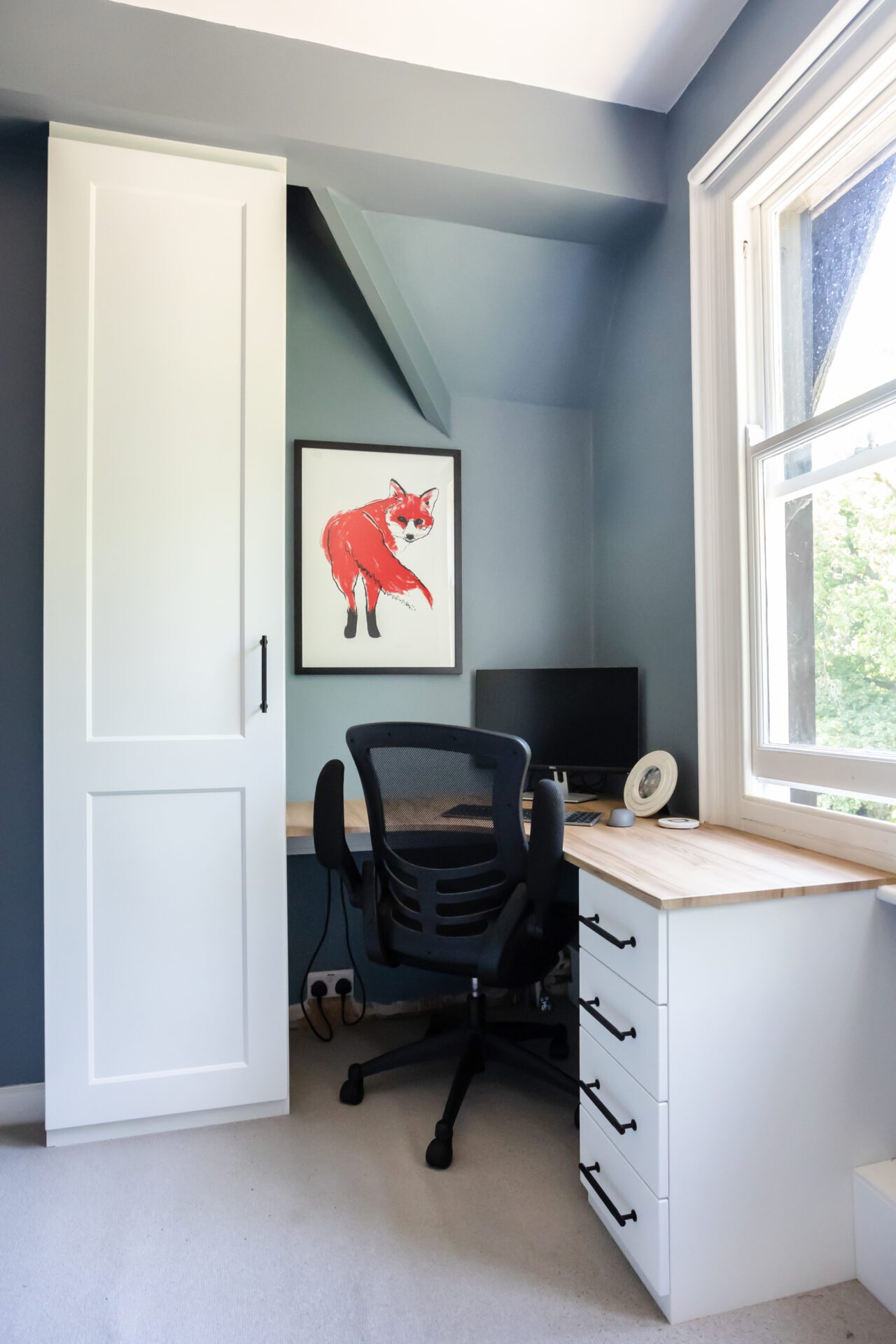Image of a home office desk, drawers and cupboard