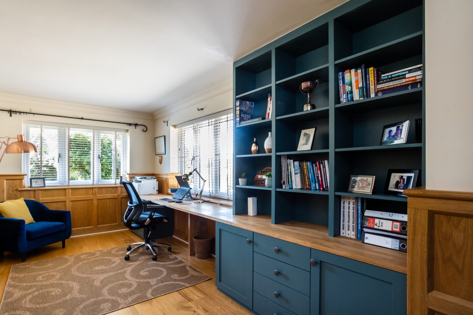 Image of a home office with bespoke shelves, cupboards and drawers