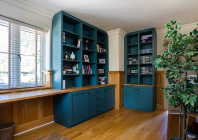 Image of a home office with bespoke shelves, cupboards and drawers