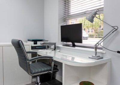 Image of a modern home office with desk and shelving
