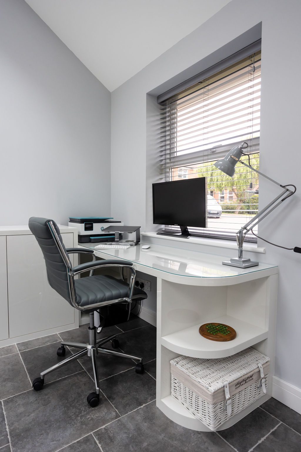 Image of a modern home office with desk and shelving